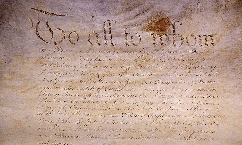An image of an original handwritten version of the Articles of Confederation.