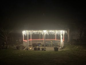 A picture of a gazebo adorned with Christmas lights.