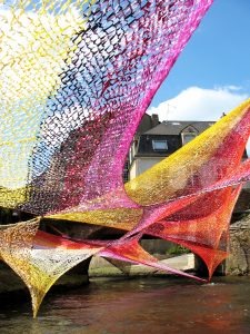 Colorful ribbons above river.