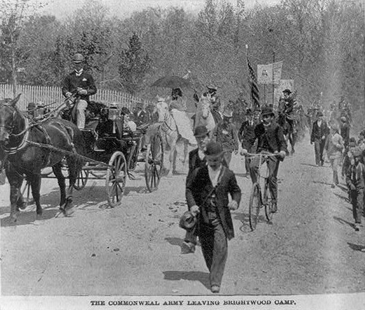 A photograph shows Coxey’s Army on the march, with protestors walking, mounted on horseback, and riding on bicycles and in horse-drawn buggies.