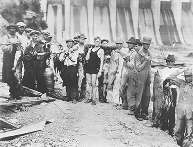 A photograph shows a group of TVA workers standing in front of the Wilson Dam.