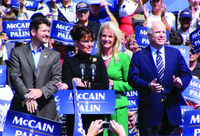 A photograph shows John and Cindy McCain and Sarah and Todd Palin standing at a lectern, surrounded by supporters holding “McCain / Palin” signs.