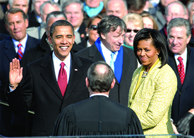A photograph shows Barack Obama taking the oath of office beside Michelle Obama.