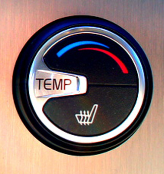 Image of a typical temperature control in an automobile. The circular dial is labeled “TEMP”. At top are two curved arrows, blue pointing to the left for cooling, and red pointing to right for heating. At bottom is an icon for the heated seats.