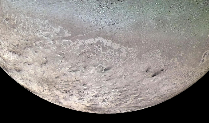 An image of Neptune’s Moon Triton. At the bottom of the image is the southern polar cap.