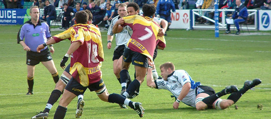 Rugby players colliding during a rugby match.