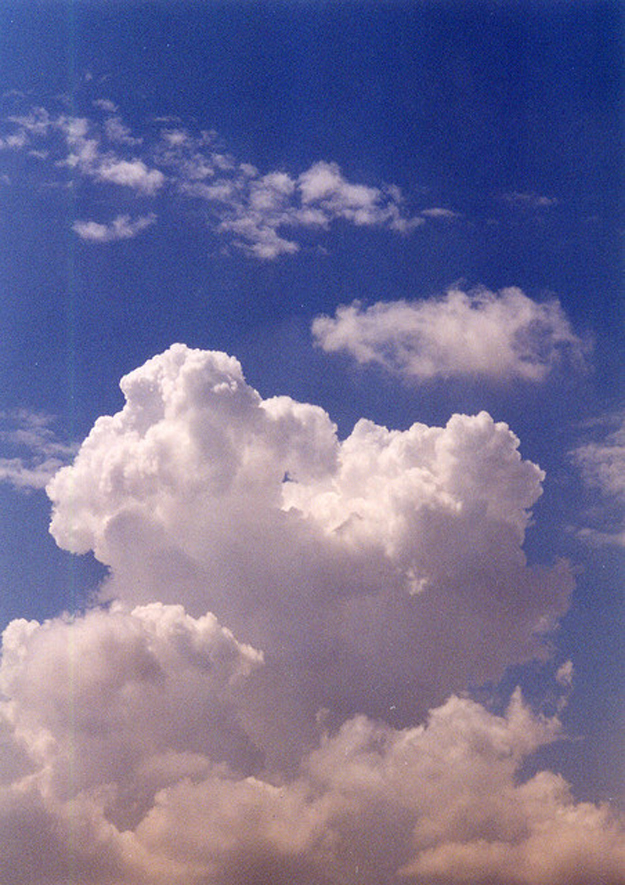 The figure shows a cumulus cloud in a blue sky.